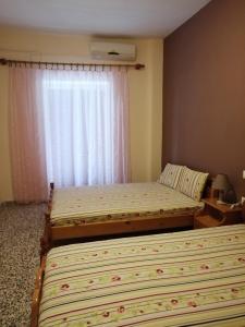 Postel nebo postele na pokoji v ubytování Ο Ακλόνητος
