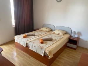 a bedroom with a bed with two pillows on it at Hotel Atanasov 1 in Primorsko