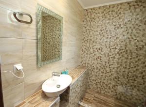 a bathroom with a sink and a mirror at Panos House in Koinyra +26 photos