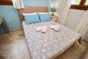 two stuffed animals are sitting on a bed at Panos House in Koinyra