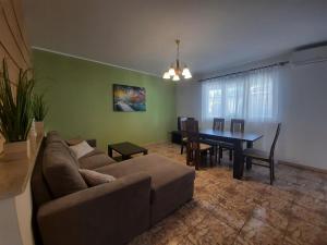 a living room with a couch and a dining room table at Villa Doris YourCroatiaHoliday in Premantura