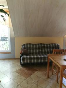 a living room with a couch and a table at Czerwonki agroturystyka u Beaty in Czerwonki