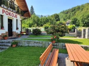 a wooden bench in front of a building at Willa OLA in Karpacz