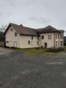 a large white house with a driveway in front of it at les accacias in Moyenmoutier
