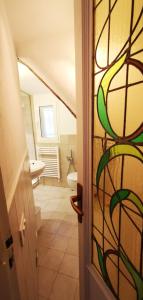 a bathroom with a bathroom door with astained glass window at Due balconcini sul mare in Santa Margherita Ligure +9 photos