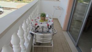 a cake sitting on a chair on a balcony at Apartamento - 2 a 4 Pessoas- Piscina in Olhos de Água