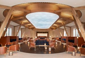 a large lobby with chairs and a large ceiling at Château de Ferrand in Saint-Émilion