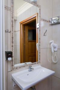 a bathroom with a sink and a mirror at Hotel Bastion in Kostrzyn nad Odrą