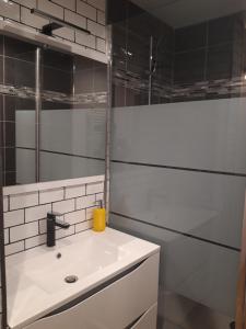 een witte badkamer met een wastafel en een spiegel bij l'escale in Montamisé