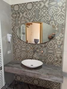 a bathroom sink with a large mirror on a wall at Vecchia Posta Casa Vacanze in Montecatini Terme +25 photos