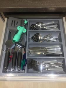 a drawer full of utensils in a cabinet at Huntley lodge pp in Liverpool