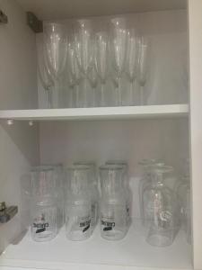 a row of wine glasses sitting on a shelf at Huntley lodge pp in Liverpool