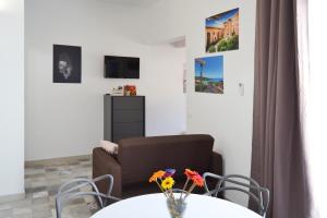 a living room with a table and a chair and a couch at Quattroquarti Stradivari Home in Noto