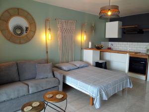 a living room with a bed and a couch at Karukera Lodge in Le Gosier