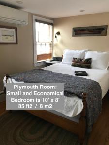 a bedroom with a large bed with a sign on it at Revere Guest House in Provincetown