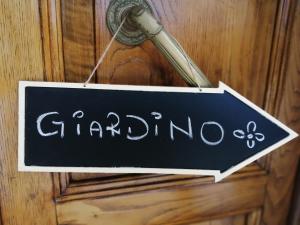 a sign that says garma hanging on a door at jasmine cottage in Luni