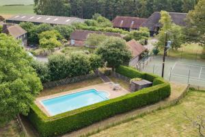 an aerial view of a house with a swimming pool at Great Higham Barn by Bloom Stays in Canterbury