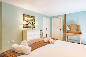 a bedroom with a large bed with towels on it at Great Higham Barn by Bloom Stays in Canterbury +29 photos