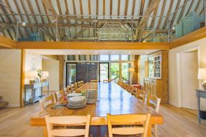 a large dining room with a long table and chairs at Great Higham Barn by Bloom Stays in Canterbury