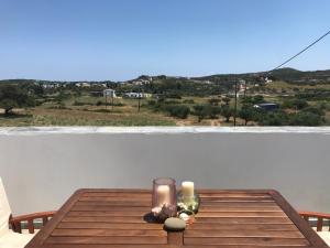 a table with two candles on top of a balcony at Livadi center mountain view apartment in Livadi