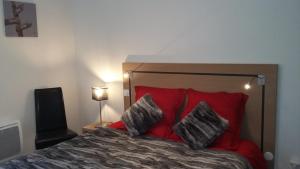 a bedroom with a red bed with two pillows at T2 cabine vue montagne Valnéa Peyragudes in Germ