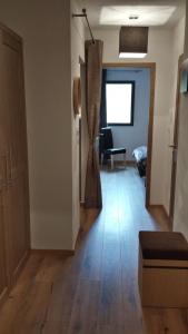 an empty room with a hallway with a door and a chair at T2 cabine vue montagne Valnéa Peyragudes in Germ +6 photos