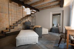 sala de estar con sofá y escalera en CasaZavi, en Belluno