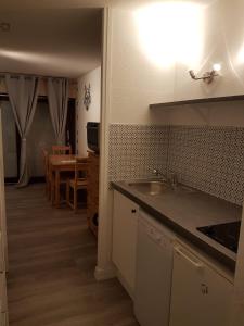 a kitchen with a sink and a counter top at Studio tout confort avec vue sur les sommets in Combloux