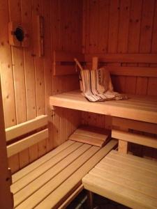 a sauna with wooden walls and benches in it at Haus zur Therme in Bad Mitterndorf