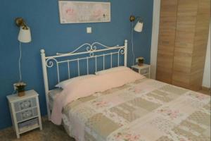 a bedroom with a bed with two night stands and two lamps at Zefis Appartment in Ouranoupoli