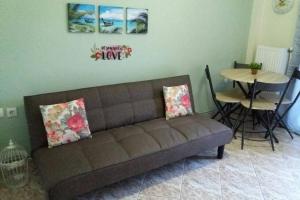 a living room with a couch and a table at Zefis Appartment in Ouranoupoli