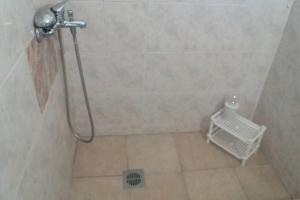 a bathroom with a shower with a basket in the floor at Zefis Appartment in Ouranoupoli +42 photos