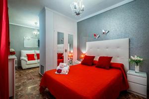 a bedroom with a large red bed with a red blanket at Hotel Gines in Ginés