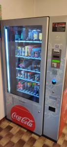 a coca cola refrigerator with its door open at EC Hotel Elchingen in Elchingen