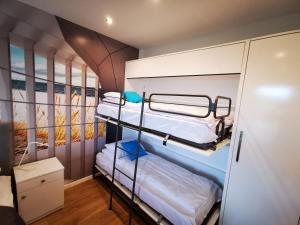 a room with three bunk beds in it at M&K Apartamenty Deluxe Gdańsk Sobieszewo 2 in Gdańsk