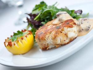 a plate of food with chicken and vegetables on a table at The Crown Inn in East Rudham