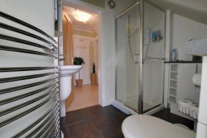 a bathroom with a shower and a toilet and a sink at King Street Apartment in Inverness +33 photos