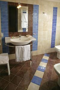 a bathroom with a sink and a toilet at Castellammare Smart Rooms in Castellammare del Golfo