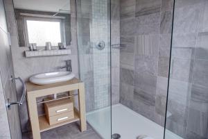a bathroom with a shower and a sink and a toilet at The Orwell Hotel in Felixstowe