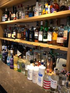 a shelf filled with lots of bottles of alcohol at Queenswood Hotel in Weston-super-Mare