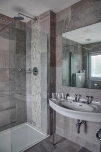 a bathroom with a sink and a shower at The Orwell Hotel in Felixstowe