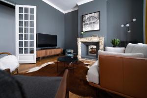 a living room with a couch and a fireplace at Centre ville - Appartement 3 chambres & Terrasse - La Clé des Sacres in Reims