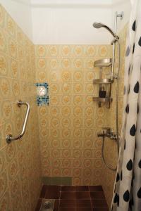a bathroom with a shower and a tiled floor at Puntin Rooms apartman in Korčula
