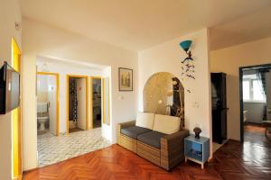 a living room with a couch in a room at Puntin Rooms apartman in Korčula