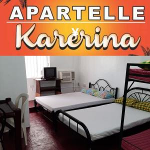 two beds in a room with a karichen kaza sign at Antipolo Budget Hostel,Family Rooms in Antipolo