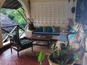a living room with a couch and a table at Tropical Garden House in Kilifi