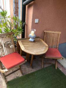 a wooden table and two chairs with a candle on it at Your Studio in Fichtenau