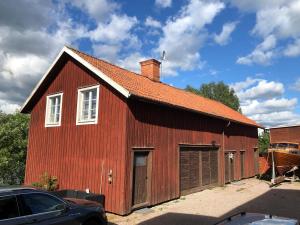 a red barn with a gambrel roof at Älvtomt in Krylbo