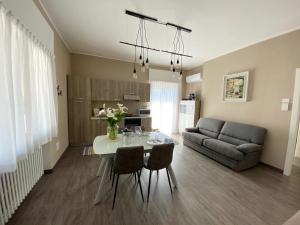 a living room with a table and a couch at Appartamento Renzo, Dongo, Lago di Como in Dongo