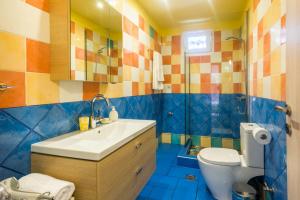 a bathroom with a sink and a toilet at Dimitra's Garden - Holiday Apartments in Parga +25 photos